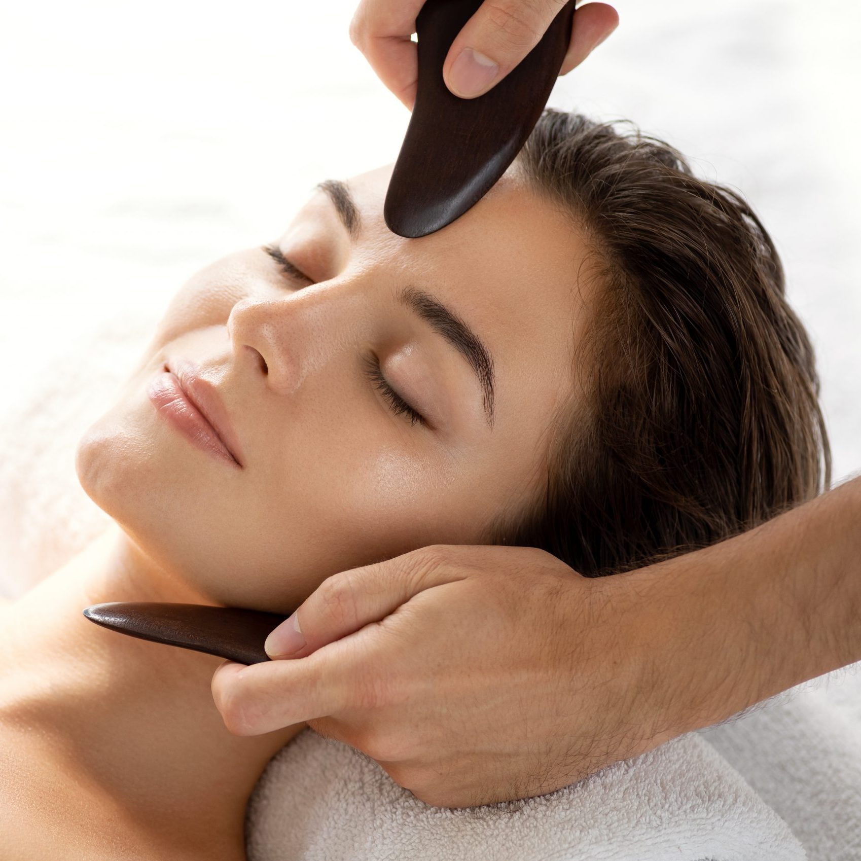 Young and beautiful woman during Chinese traditional massage - Gua Sha